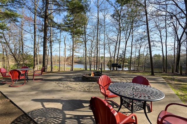 262 Shrouder Rd, Broken Bow, OK 74728 - view of patio / terrace with an outdoor fire pit, a water view, and view of scattered trees