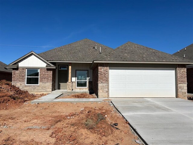 19604 Taggert Dr, Edmond, OK 73012 - single story home with a shingled roof, concrete driveway, a garage, and brick siding