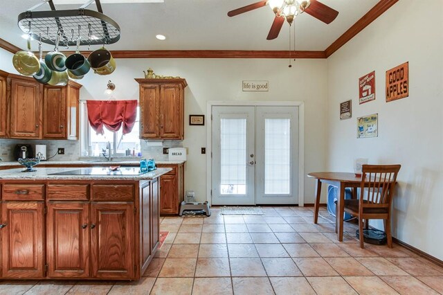 1408 Carlton, Edmond, OK 73034 - kitchen featuring ornamental molding, french doors, ceiling fan, brown cabinets, and a sink