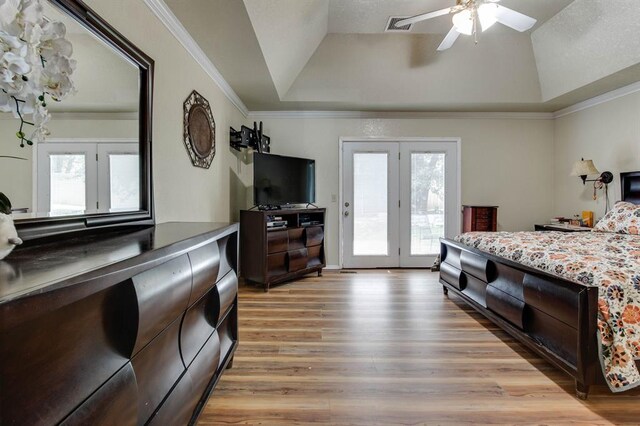1408 Carlton, Edmond, OK 73034 - bedroom with a raised ceiling, access to outside, multiple windows, light wood-type flooring, and crown molding