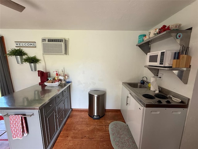 410052 E 1103rd Rd, Checotah, OK 74426 - kitchen with open shelves, white appliances, stainless steel counters, hardwood / wood-style floors, and a peninsula