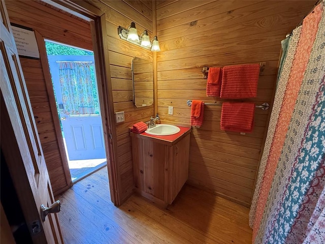 410052 E 1103rd Rd, Checotah, OK 74426 - full bathroom with wood finished floors, vanity, and wooden walls