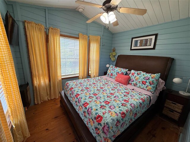410052 E 1103rd Rd, Checotah, OK 74426 - bedroom featuring hardwood / wood-style flooring, vaulted ceiling, ceiling fan, and wood walls