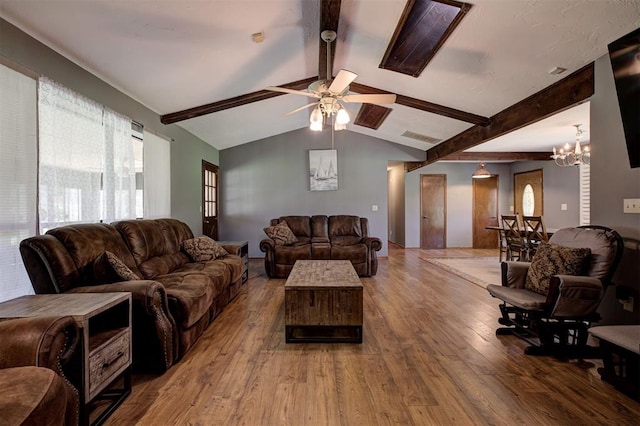 11129 E Thayer St, Midwest City, OK 73130 - living room featuring wood finished floors, a ceiling fan, and a chandelier