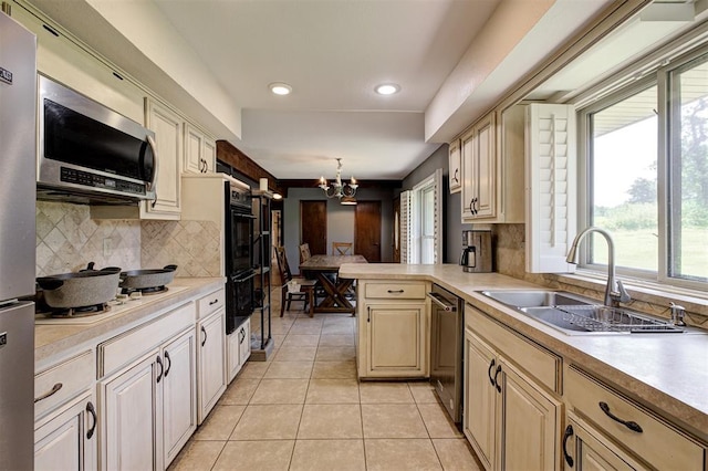 11129 E Thayer St, Midwest City, OK 73130 - kitchen with appliances with stainless steel finishes, plenty of natural light, light countertops, and recessed lighting