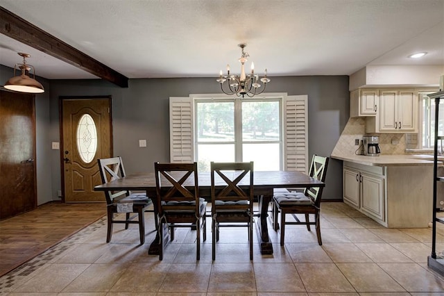 11129 E Thayer St, Midwest City, OK 73130 - dining room with a chandelier, beam ceiling, recessed lighting, and light tile patterned floors