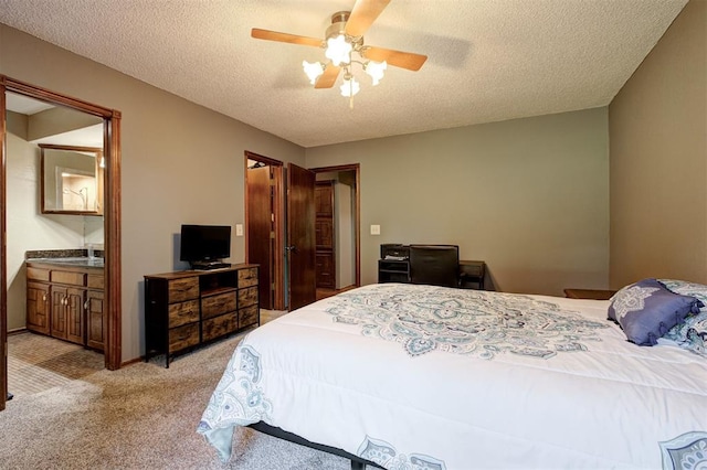 11129 E Thayer St, Midwest City, OK 73130 - bedroom featuring a textured ceiling, light colored carpet, ceiling fan, and ensuite bath