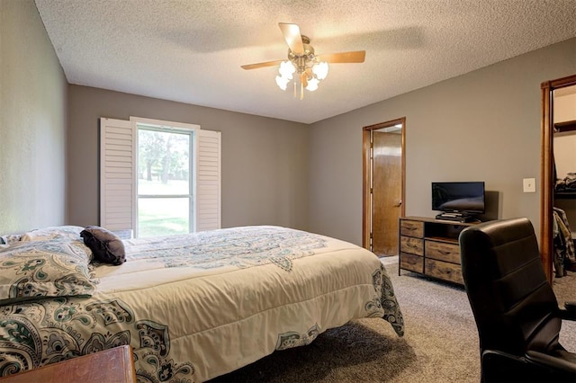 11129 E Thayer St, Midwest City, OK 73130 - bedroom featuring carpet, a textured ceiling, and ceiling fan