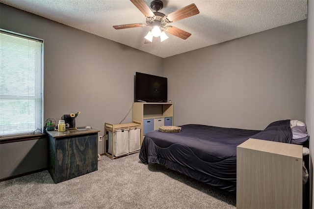 11129 E Thayer St, Midwest City, OK 73130 - carpeted bedroom with a textured ceiling and a ceiling fan
