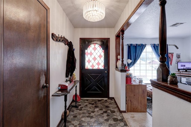 801 Bonnie Ave, Purcell, OK 73080 - foyer entrance featuring a chandelier and baseboards