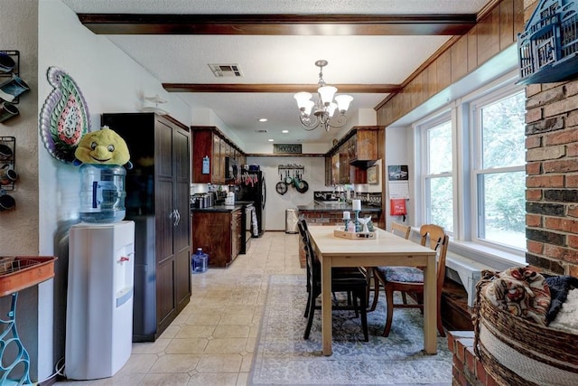 801 Bonnie Ave, Purcell, OK 73080 - dining room featuring a chandelier and light tile patterned floors