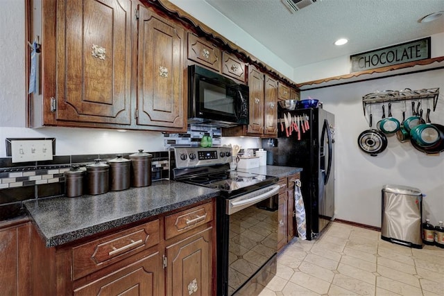 801 Bonnie Ave, Purcell, OK 73080 - kitchen featuring black appliances, dark countertops, a textured ceiling, baseboards, and recessed lighting
