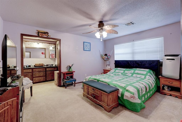 801 Bonnie Ave, Purcell, OK 73080 - bedroom with light carpet, a textured ceiling, and a ceiling fan