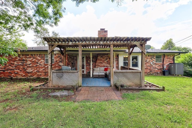 801 Bonnie Ave, Purcell, OK 73080 - rear view of house featuring an outdoor hangout area, central AC, a lawn, a chimney, and brick siding