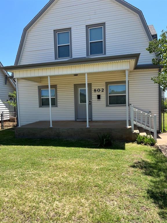 802 N Hudson St, Altus, OK 73521 - colonial inspired home featuring a gambrel roof and covered porch