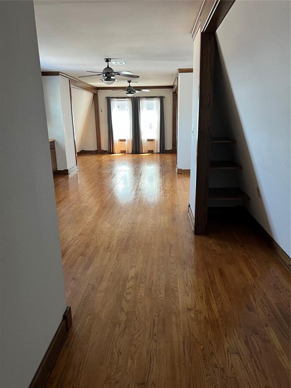 802 N Hudson St, Altus, OK 73521 - corridor with dark wood-type flooring and stairway