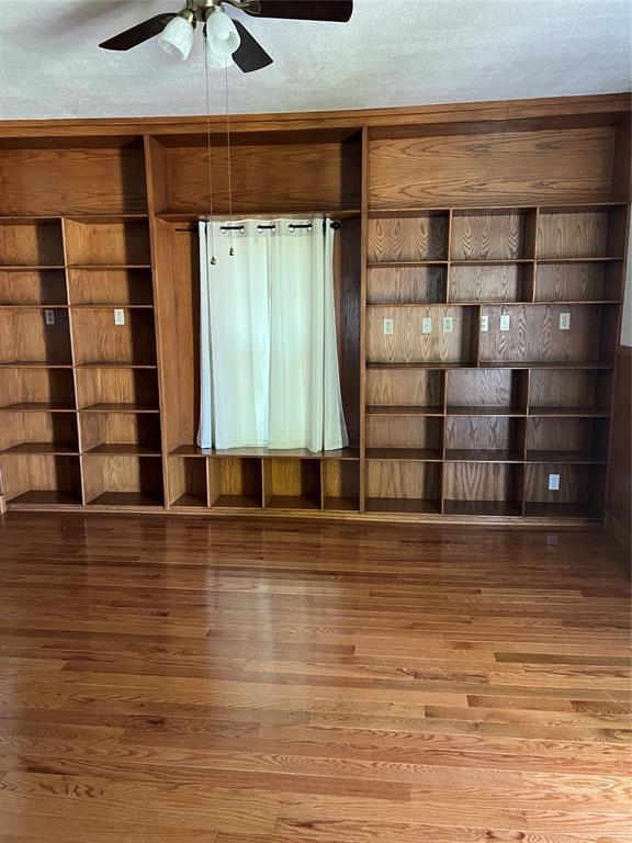 802 N Hudson St, Altus, OK 73521 - unfurnished living room featuring wood finished floors and a ceiling fan