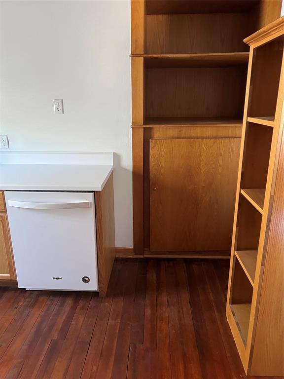 802 N Hudson St, Altus, OK 73521 - detailed view of white dishwasher and wood finished floors
