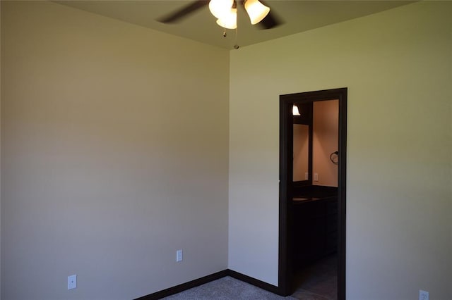 1713 Rain Tree Ln, Midwest City, OK 73130 - spare room with a ceiling fan, baseboards, and dark colored carpet