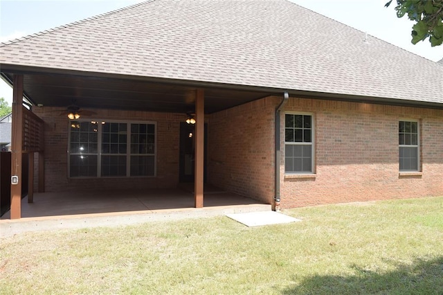 1713 Rain Tree Ln, Midwest City, OK 73130 - back of house featuring roof with shingles, a yard, a patio, ceiling fan, and brick siding