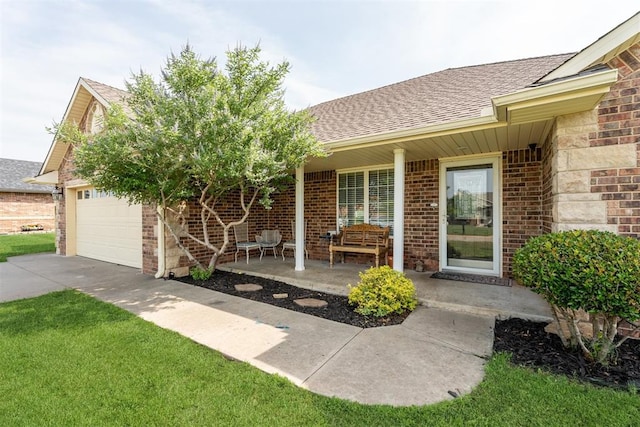 2303 Whispering Pine Blvd, Shawnee, OK 74804 - doorway to property with a shingled roof, brick siding, concrete driveway, a garage, and covered porch