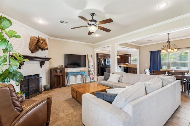 2303 Whispering Pine Blvd, Shawnee, OK 74804 - living area with a chandelier, ceiling fan, a brick fireplace, recessed lighting, and ornamental molding