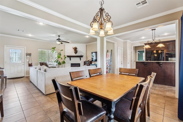 2303 Whispering Pine Blvd, Shawnee, OK 74804 - dining space with light tile patterned floors, ceiling fan, recessed lighting, a fireplace, and a chandelier