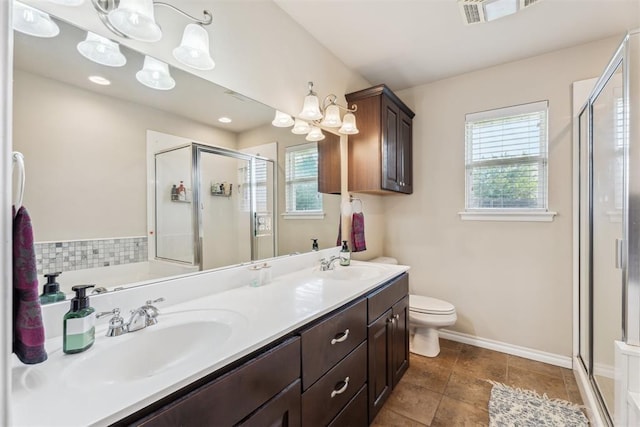 2303 Whispering Pine Blvd, Shawnee, OK 74804 - bathroom featuring a shower stall, double vanity, and plenty of natural light