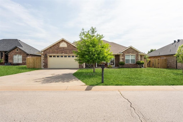 2303 Whispering Pine Blvd, Shawnee, OK 74804 - ranch-style home with concrete driveway, an attached garage, and brick siding