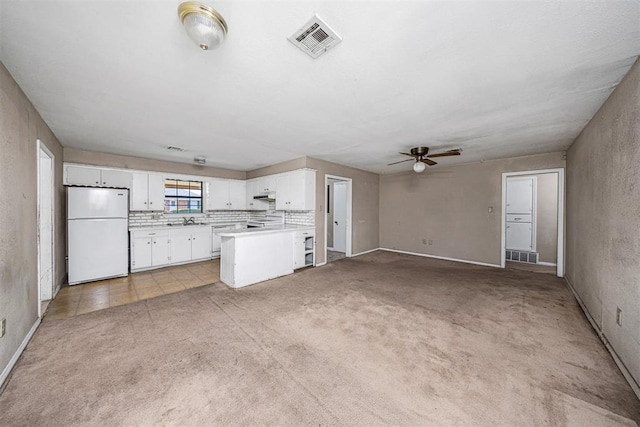 814 NW 48th St, Lawton, OK 73505 - unfurnished living room featuring ceiling fan, light carpet, a sink, and baseboards