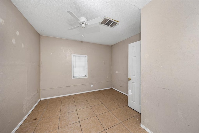 814 NW 48th St, Lawton, OK 73505 - spare room featuring ceiling fan, light tile patterned flooring, a textured ceiling, and baseboards