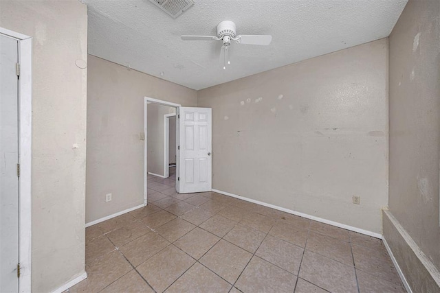 814 NW 48th St, Lawton, OK 73505 - unfurnished room with tile patterned flooring, ceiling fan, a textured ceiling, and baseboards