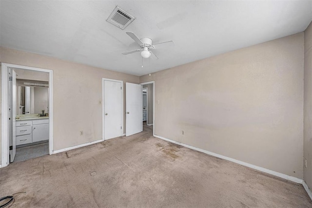 814 NW 48th St, Lawton, OK 73505 - unfurnished bedroom featuring baseboards, carpet flooring, ensuite bathroom, and ceiling fan