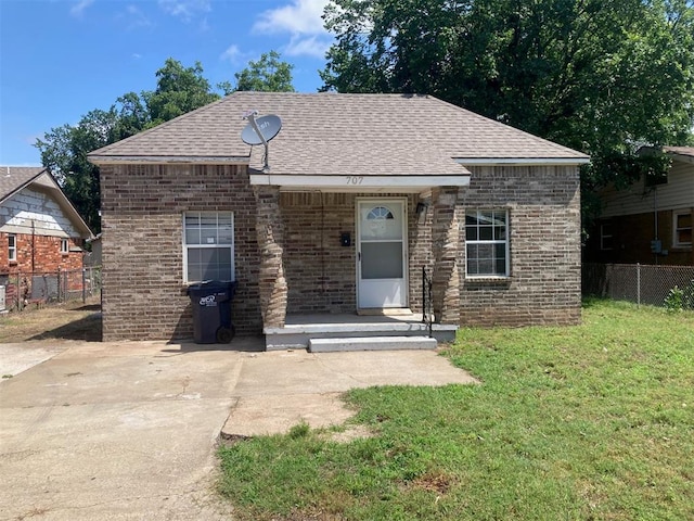 707 W Texas Ave, Anadarko, OK 73005 - view of front of house with a shingled roof and brick siding