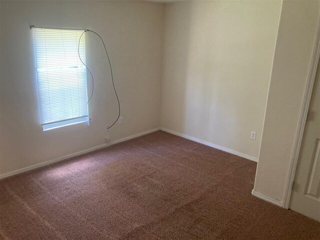 707 W Texas Ave, Anadarko, OK 73005 - carpeted empty room with baseboards