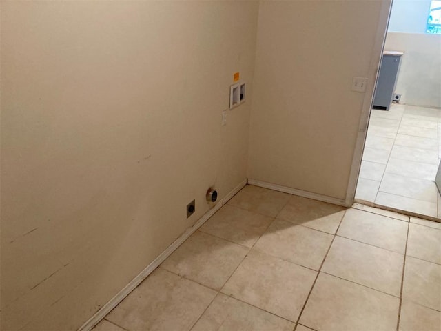 707 W Texas Ave, Anadarko, OK 73005 - laundry area featuring washer hookup, hookup for an electric dryer, light tile patterned floors, and baseboards