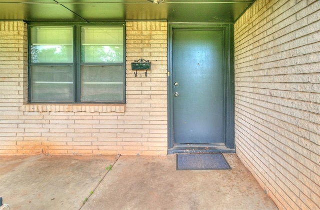 824 E Rose Dr, Midwest City, OK 73110 - property entrance featuring brick siding