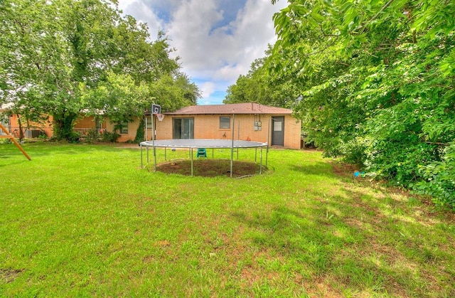 824 E Rose Dr, Midwest City, OK 73110 - view of grassy yard with a trampoline