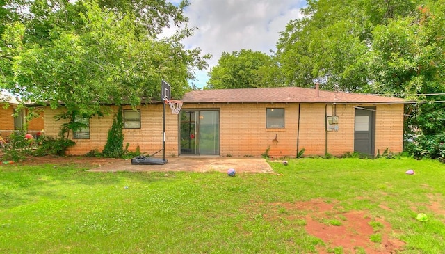 824 E Rose Dr, Midwest City, OK 73110 - back of property with a yard, a patio area, and brick siding