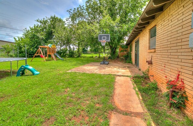 824 E Rose Dr, Midwest City, OK 73110 - view of yard featuring a trampoline, a playground, and a patio