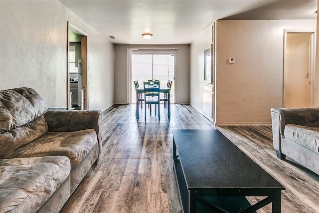 824 E Rose Dr, Midwest City, OK 73110 - living area with wood finished floors and a textured wall