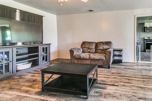 824 E Rose Dr, Midwest City, OK 73110 - living area featuring wood finished floors and baseboards
