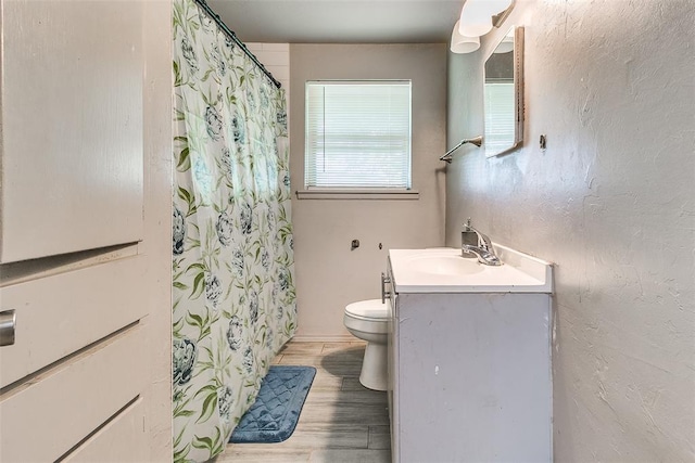 824 E Rose Dr, Midwest City, OK 73110 - bathroom featuring vanity, wood finished floors, and a shower with shower curtain