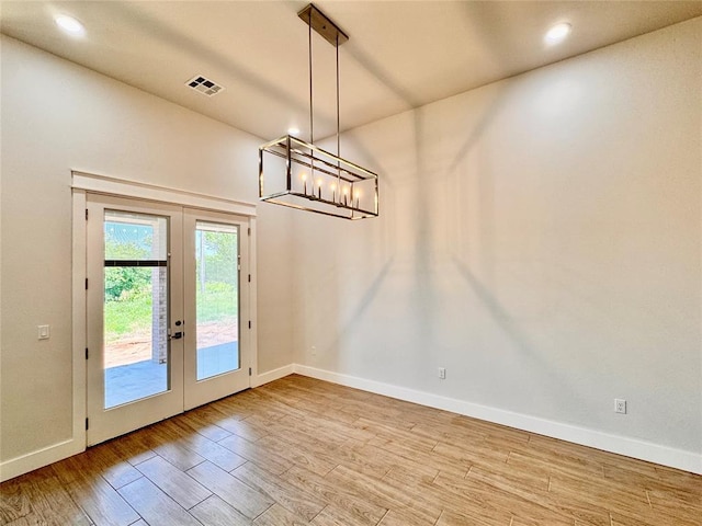 10165 NW 100th St, Yukon, OK 73099 - unfurnished dining area featuring french doors, wood finished floors, a chandelier, and recessed lighting