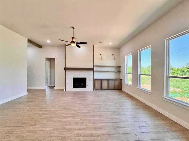 10165 NW 100th St, Yukon, OK 73099 - unfurnished living room with light wood finished floors, recessed lighting, ceiling fan, and a fireplace