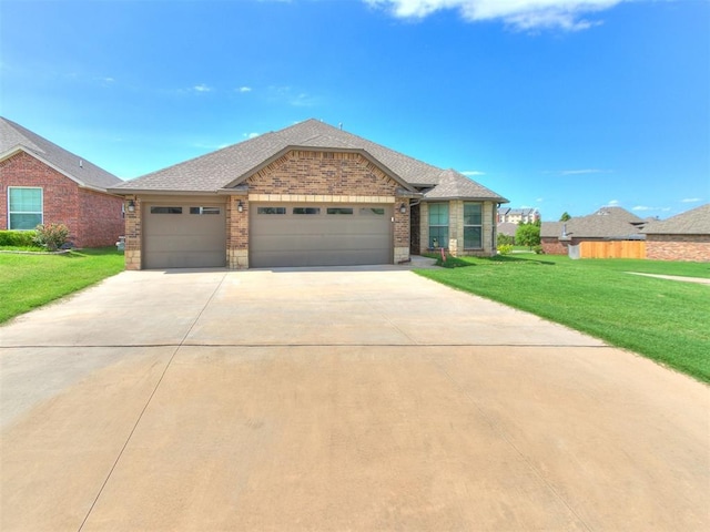 5512 Cheyenne Rd, Warr Acres, OK 73132 - view of front of house featuring a garage, concrete driveway, a front yard, brick siding, and roof with shingles