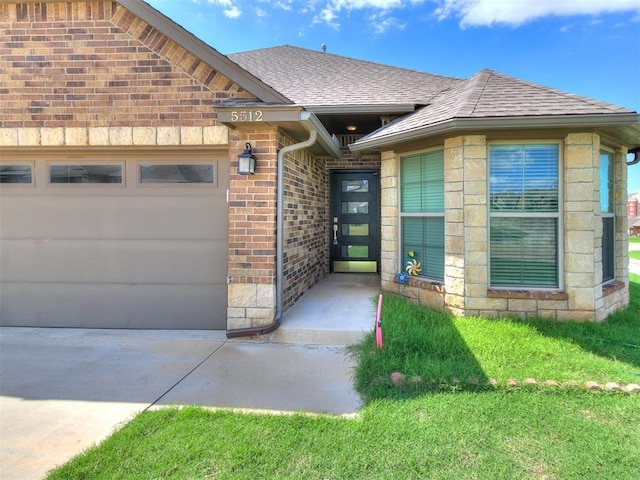 5512 Cheyenne Rd, Warr Acres, OK 73132 - view of exterior entry with an attached garage, driveway, brick siding, and a shingled roof