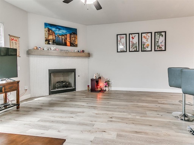 5512 Cheyenne Rd, Warr Acres, OK 73132 - living room with wood finished floors, a ceiling fan, and a tile fireplace
