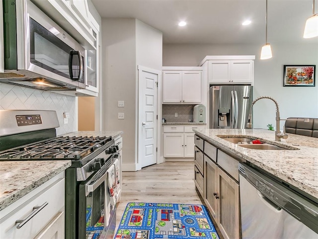 5512 Cheyenne Rd, Warr Acres, OK 73132 - kitchen featuring stainless steel appliances, tasteful backsplash, light wood finished floors, white cabinetry, and light stone counters