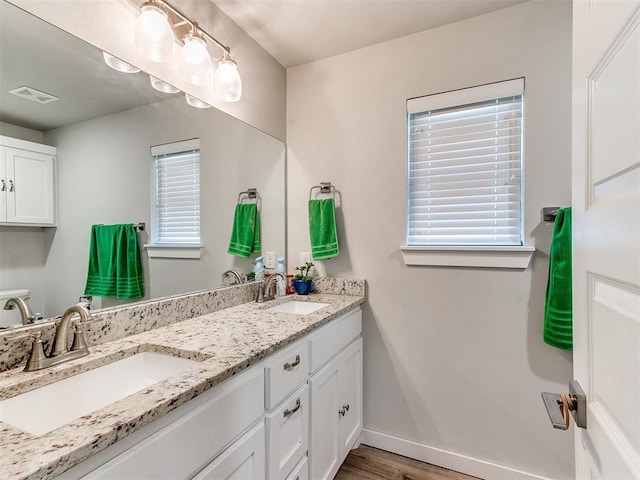 5512 Cheyenne Rd, Warr Acres, OK 73132 - full bathroom with double vanity and wood finished floors